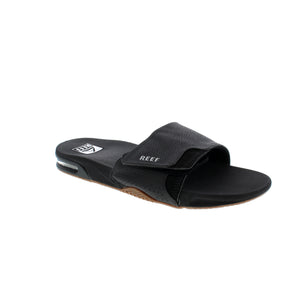 Reef Fanning slide features a velcro-adjustable strap, comfortable footbed and a built-in bottle opener on the outsole!