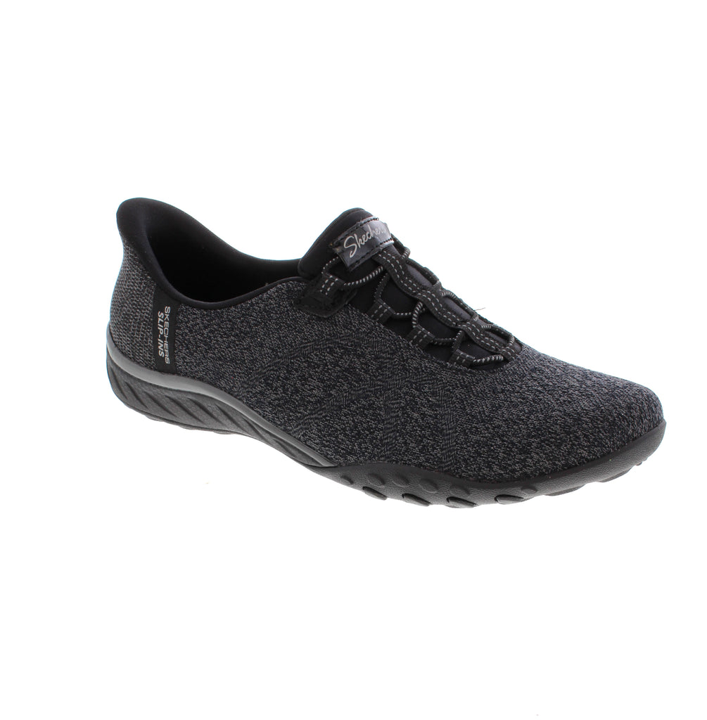 The Skechers Slip Ins Breath East Knit 100762-BBK in black offers effortless comfort with practical convenience. Featuring a breathable fabric upper and lining with a removable microfiber footbed, this slip-on accommodates orthotics for personalized support. The memory foam midsole cushions every step, while the bungee lace closure and step-in design make it easy to wear. Machine washable and vegan-friendly.&nbsp;
