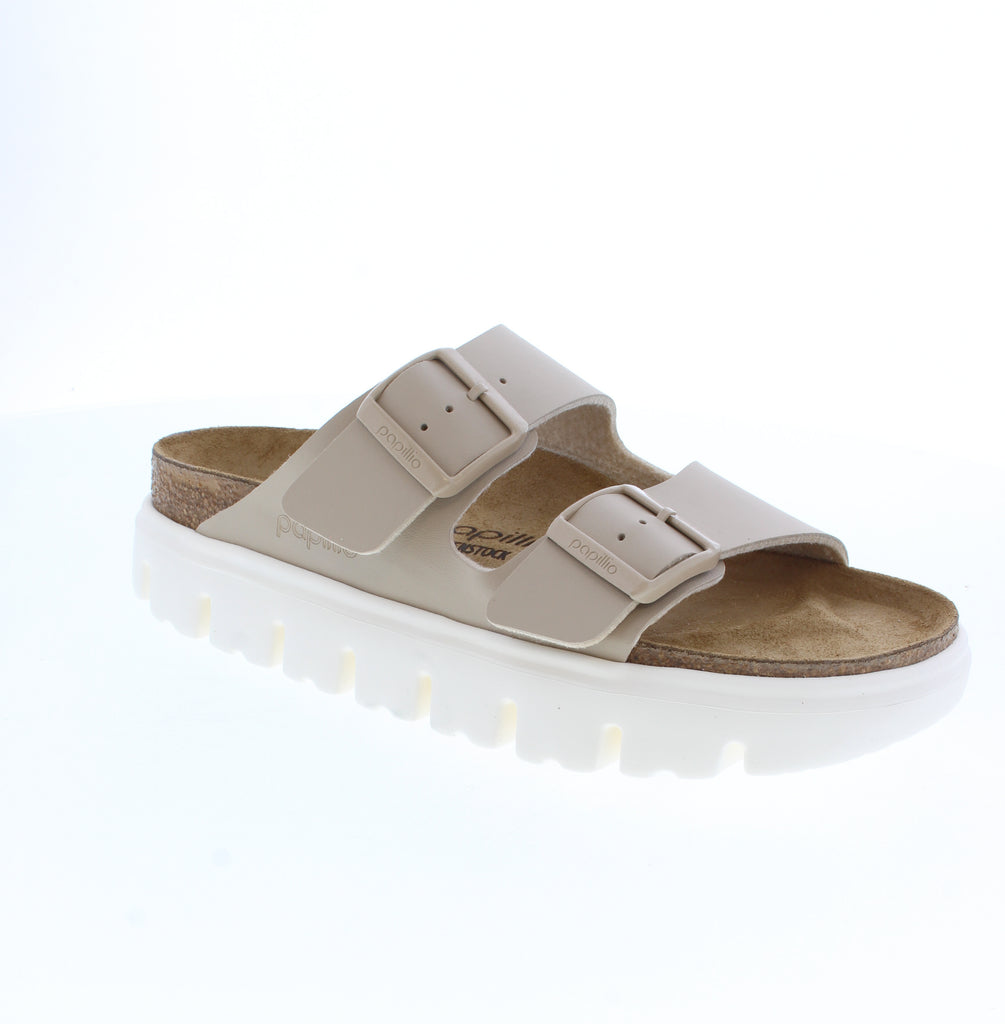 The Papillio Arizona Chunky elevates a timeless silhouette with a bold platform sole that commands attention. Crafted from premium Birko-Flor® material along with the contoured footbed provides signature Birkenstock support and comfort, making this statement sandal as functional as it is fashionable. Perfect for those seeking heritage design with contemporary edge.