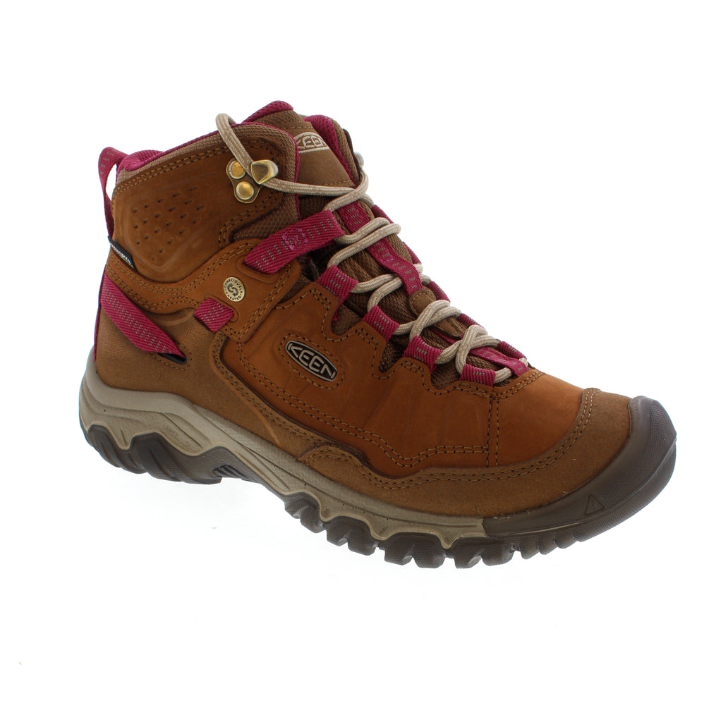 The Keen Targhee IV Mid Waterproof is a women's hiking boot featuring waterproof nubuck and leather with a 5-inch ankle height for trail support. The padded collar and lace-up closure ensure a secure fit across narrow-medium to wide feet, while the removable microfiber insole with odor control and light arch support enhance comfort. Stability technology and non-marking rubber outsole provide reliable traction on varied terrain. Orthotic-friendly design.