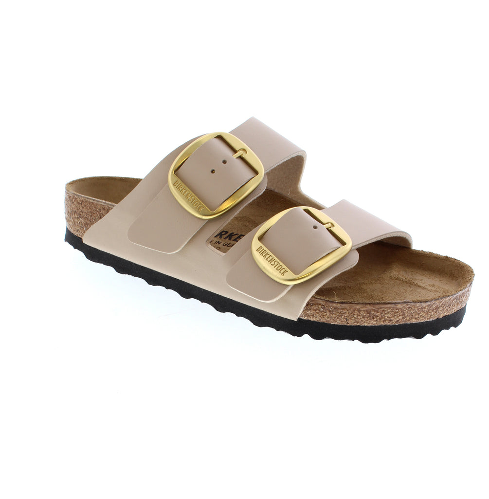 The Birkenstock Arizona Big Buckle represents five decades of refined footwear engineering. Dual oversized buckles punctuate smooth Birko-Flor uppers with understated luxury, while the contoured cork-latex footbed cradles your arch with precision support. Comfort and style converge effortlessly