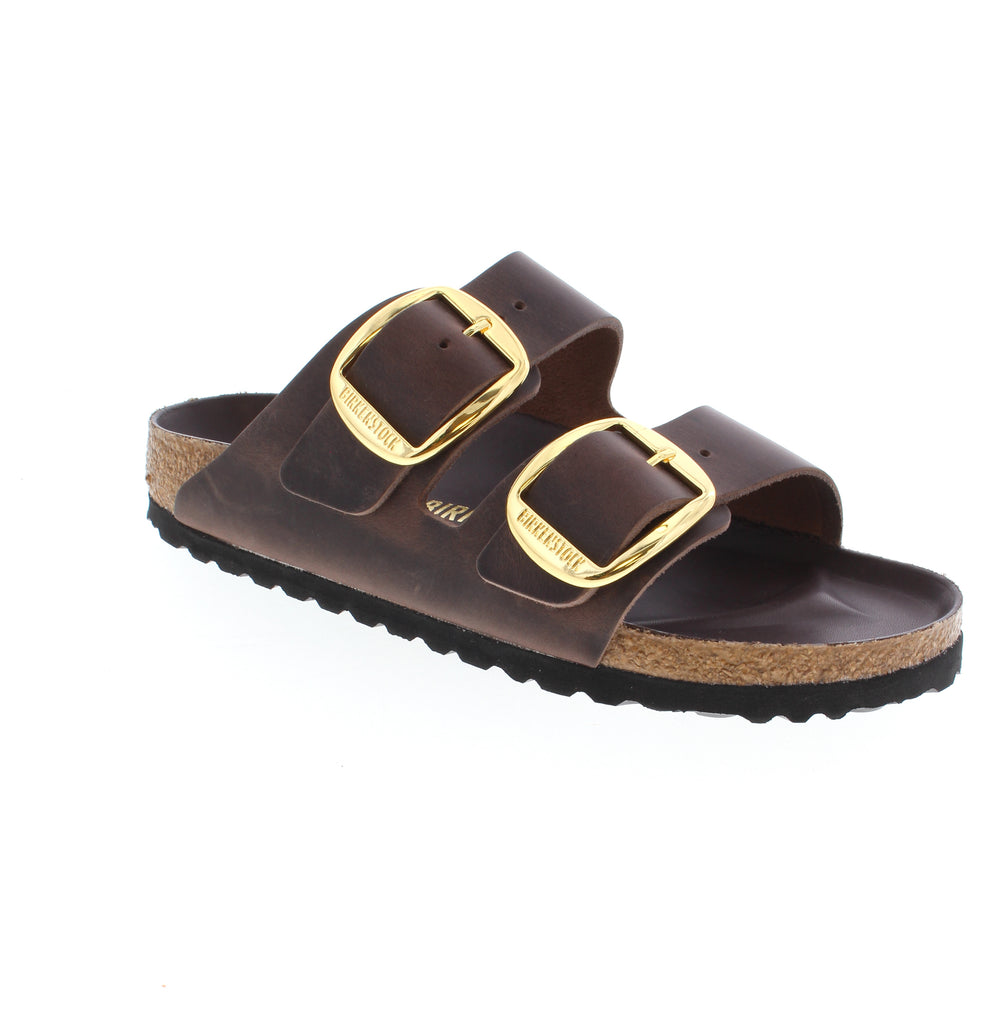 The Birkenstock Arizona Big Buckle in rich Habana leather combines timeless style with exceptional comfort. This iconic slide features an oiled leather upper, supportive cork, with adjustable buckle strap for a customized fit. Built for all-day wear, the Arizona delivers orthopedic arch support, deep heel cup stability, and a metatarsal bar that keeps your feet naturally aligned. The hard footbed and EVA outsole provide lasting durability.