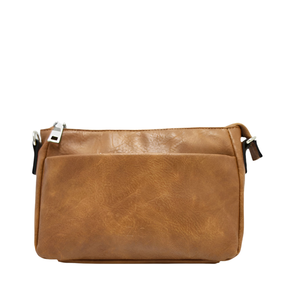 Expertly crafted with vegan leather, the Zac CM33359-122 in tan offers a sleek and sustainable option for your everyday bag. With top zippered pockets, an adjustable shoulder strap, and multiple interior pockets, including a phone pocket and one zipper pocket, this bag combines functionality and style effortlessly.