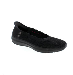 The Skechers Slip-Ins Cleo Swift in black offers stylish comfort and sustainability in one. Made from recycled materials, this vegan stretch-fit skimmer features a scalloped knit upper, a Heel Pillow, and a cushioned Air-Cooled Memory Foam insole. Your feet will thank you, and the planet will too.