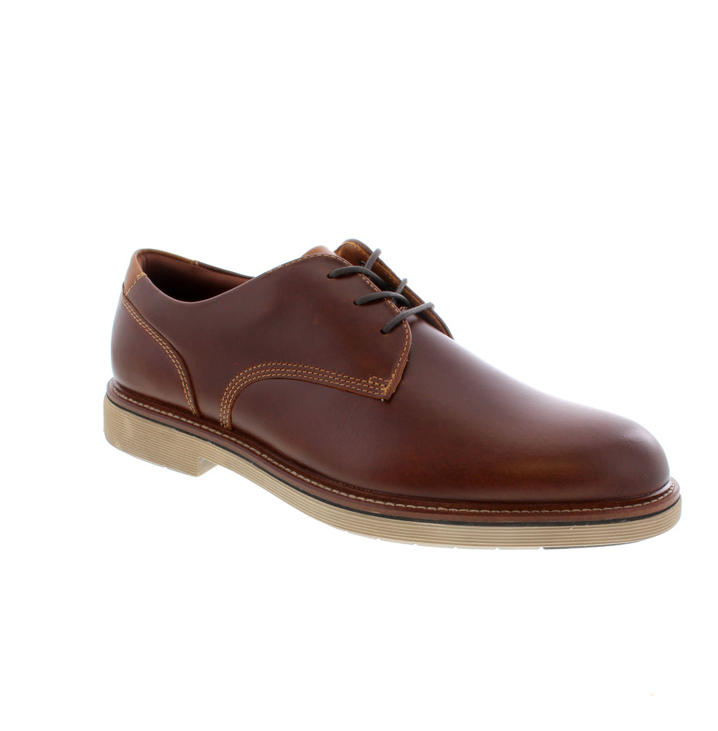 The Johnston &amp; Murphy Tyson in brown mahogany delivers timeless sophistication for the modern professional. This derby dress shoe combines premium leather construction with refined styling for boardroom confidence and everyday elegance. Leather upper, lining, and footbed provide lasting comfort and durability. Foam midsole cushioning and rubber outsole ensure all-day wearability. Lace-up entry offers a secure, adjustable fit. Fits true to size with average width and instep. 