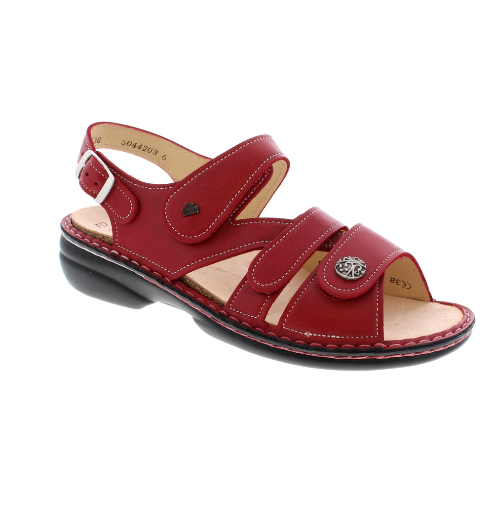 The Finn Comfort Gomera 2562-423147 sandal in red exemplifies refined comfort and versatile style. Featuring premium leather construction with a halter strap and back strap closure, this sandal accommodates both narrow-medium and medium-wide feet. The removable microfiber insole and high arch support provide exceptional comfort, while the velcro adjustment ensures a customized fit. Orthotic-friendly with a rubber outsole, this true-to-size sandal delivers understated elegance for everyday wear.