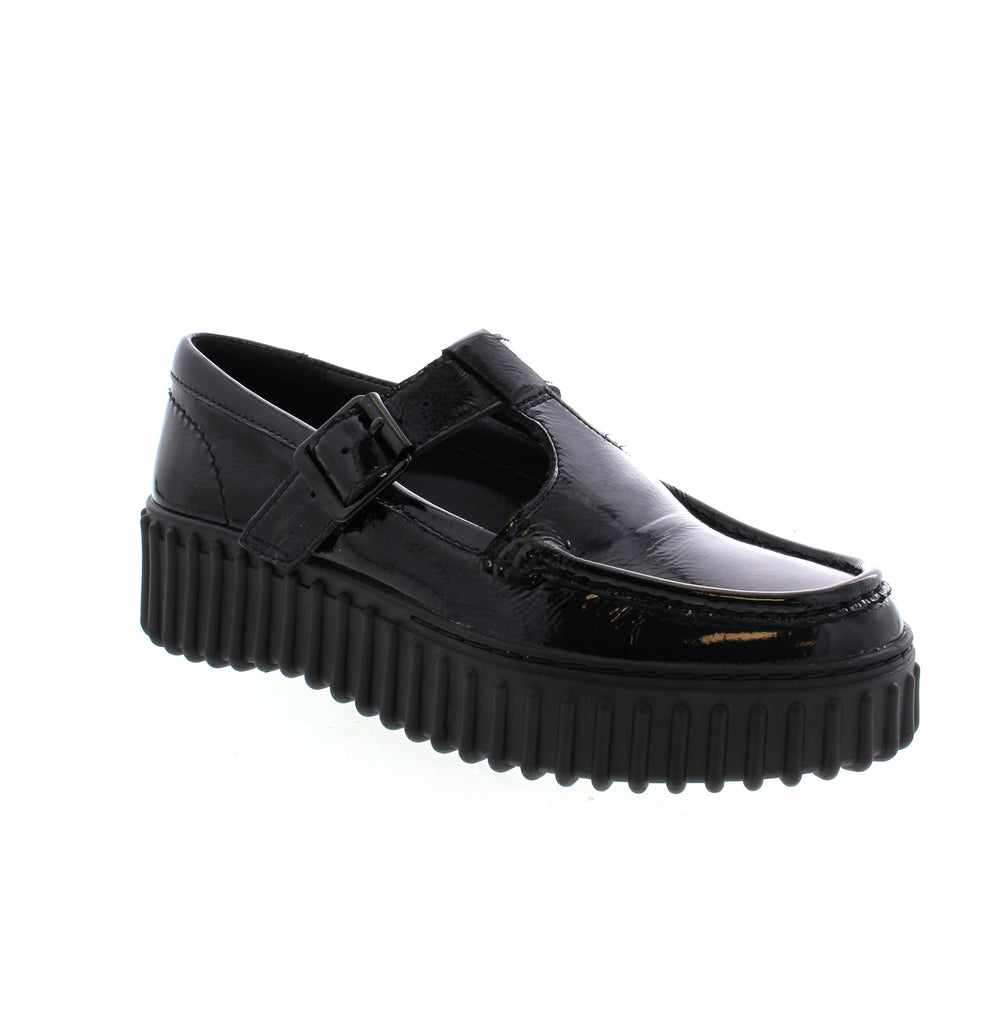 Clarks Torhill Bar shoe features a bold, ribbed outsole inspired by '90s design. This shoe combines retro style with modern comfort. The pillow-soft footbed and lightweight sole make for easy wear, while the premium patent leather and intricate stitching showcase Clarks' quality. Perfect for dress-casual occasions, the adjustable buckle adds the finishing touch.