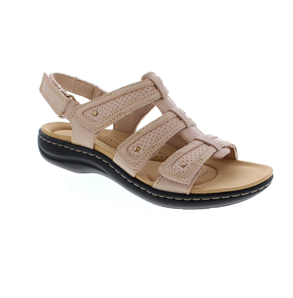 Meet your new go-to summer essential the Clarks Lauriann Ivy in a versatile sand hue. This laid-back leather slide features a secure velcro back strap and round toe silhouette that pairs with everything in your warm-weather rotation. Enjoy gentle arch support and a plush microfiber footbed that keeps comfort front and center.