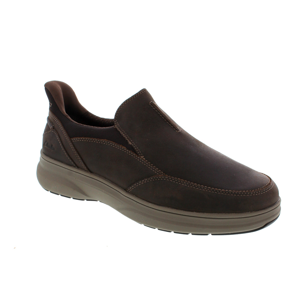 The Clarks Mullan Step in Dark Brown is a modern slip-on expertly designed for everyday wear. It features a comfortable, accommodating silhouette paired with refined detailing, highlighting Clarks’ signature craftsmanship. The easy-entry heel construction allows for quick on and off, making this versatile shoe an essential addition to any wardrobe seeking both comfort and timeless style.