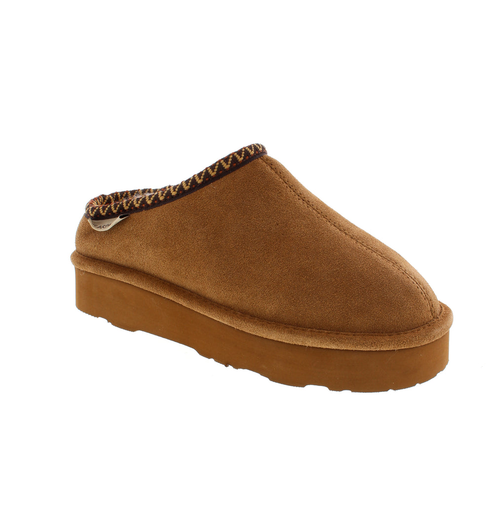 Experience exceptional comfort and durability with the Bearpaw Martis in Hickory. These classic suede slippers offer reliable support for both indoor and outdoor wear. Featuring a cozy wool blend lining, they keep your feet warm and snug, whether you're stepping out for a quick errand or relaxing at home. Designed for lasting wear, they combine practical functionality with timeless style.