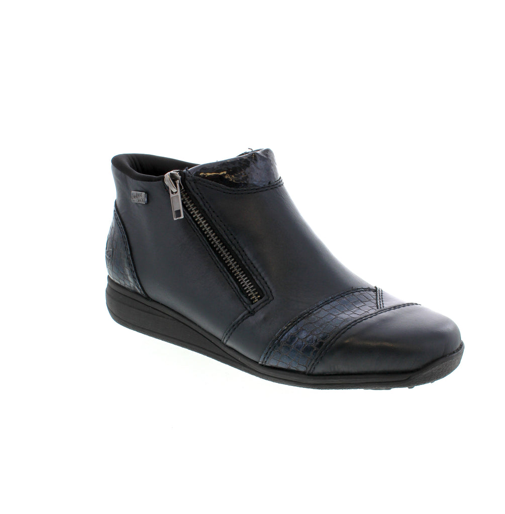 The Rieker 47254-14 ankle boot in Midnight features a premium leather upper paired with a cozy faux fur lining for superior comfort. Designed to be orthotic-friendly, it accommodates custom insoles without compromising fit. The convenient side zip ensures easy on and off, making this boot a practical yet stylish choice for daily wear in cooler seasons.