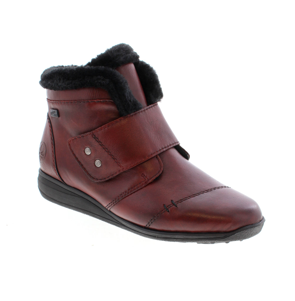Elegant burgundy ankle bootie from Rieker that combines style with everyday comfort. Crafted with a leather upper, water-resistant protection, and a supportive wedge heel, this versatile boot transitions seamlessly from casual outings to outdoor adventures.
