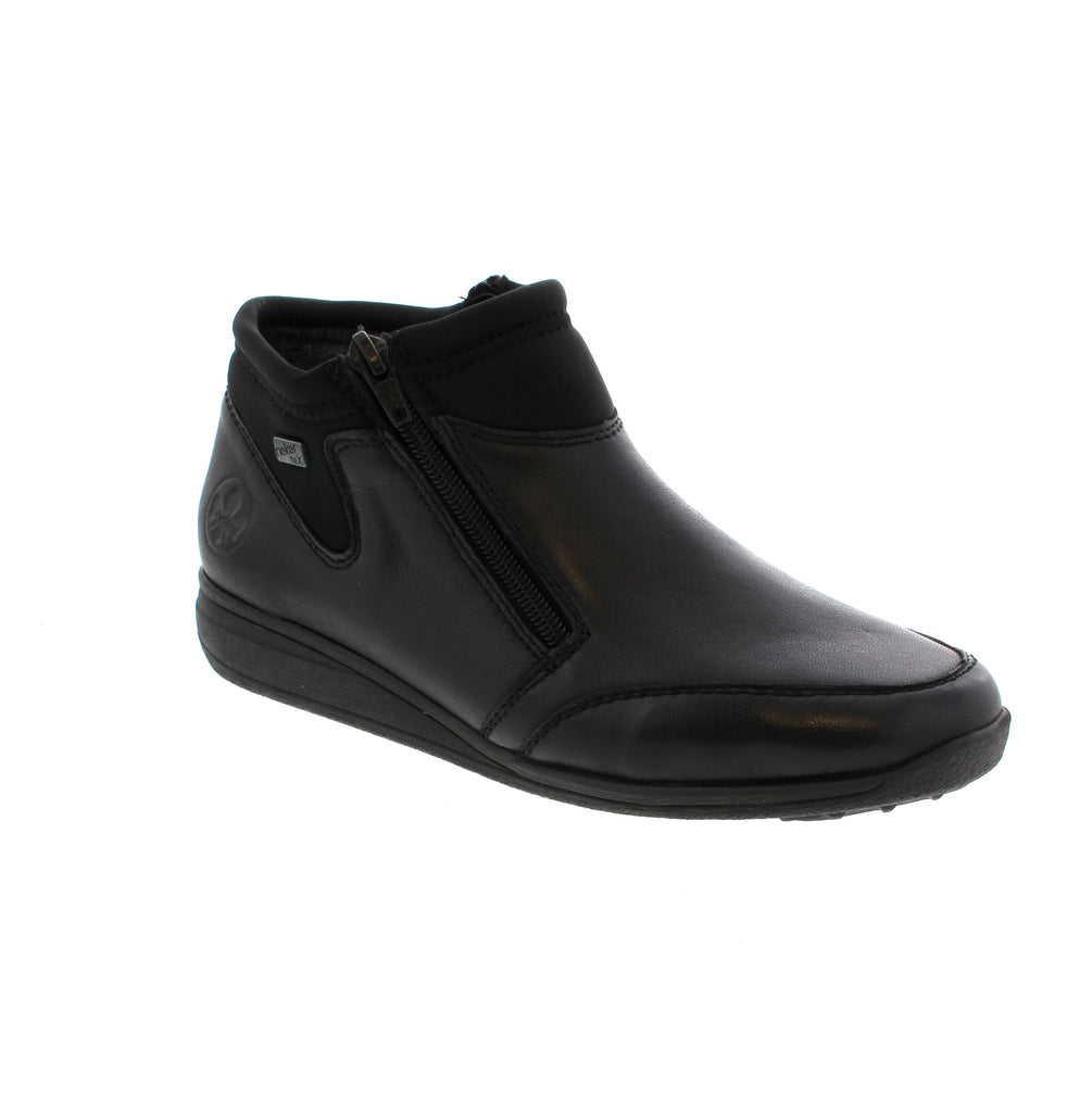 These elegant black Rieker ankle boots combine style and practicality effortlessly. Crafted from smooth leather, they feature a convenient zippers for quick wear and a grippy sole that ensures steady footing. The padded, removable insole provides lasting comfort, while the extra width offers a roomy fit. With the RiekerTEX membrane, your feet stay protected from wind and moisture, making these boots a reliable choice for any occasion.