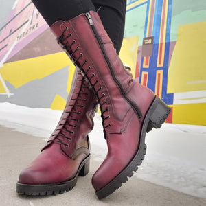 Dorking Glass D8640 heeled leather boot features a lace-up front, side zipper, and side buckle, giving it a rocker, edgy design.