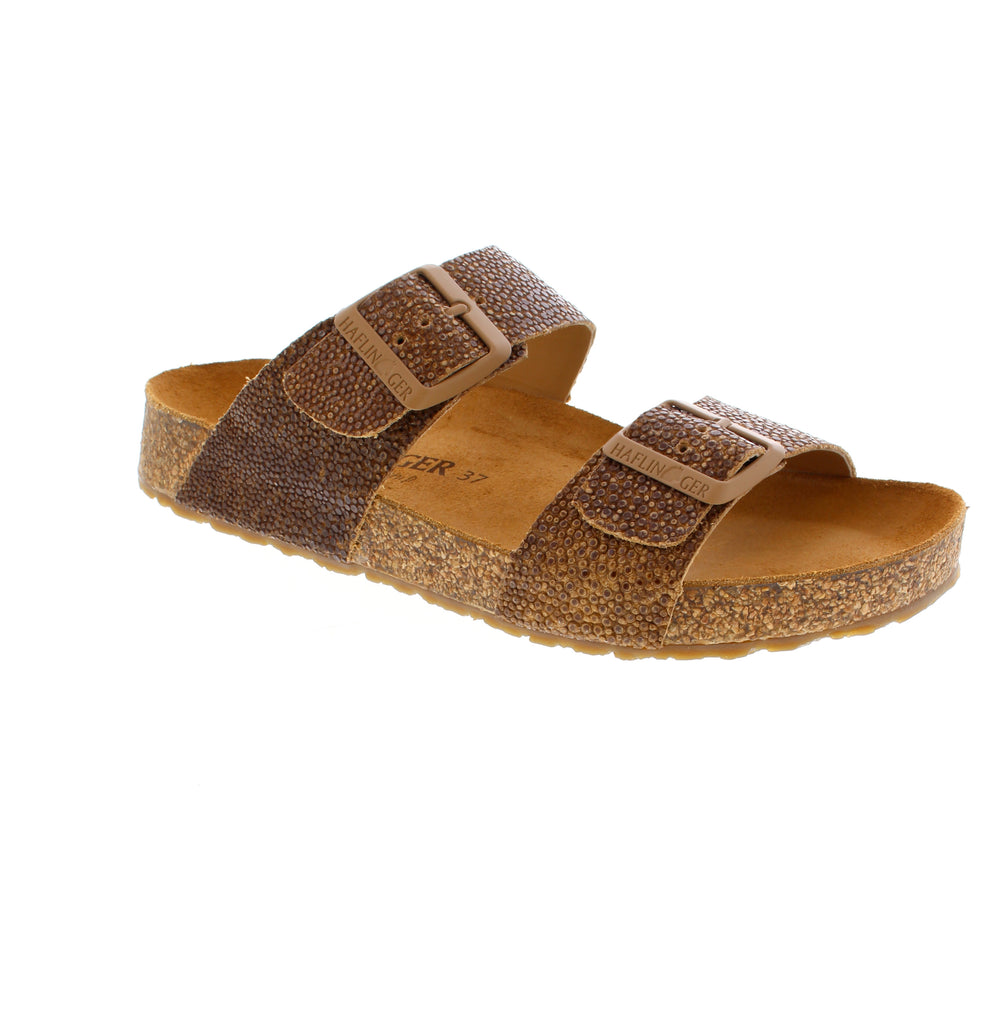 The Haflinger Andrea 819016-1806 in Brown Raie features a leather upper, suede footbed, and cork midsole for comfortable everyday wear. Its rocker bottom heel, toe bar, and high arch support work together to reduce fatigue. The buckle closure and rubber outsole provide secure footing.