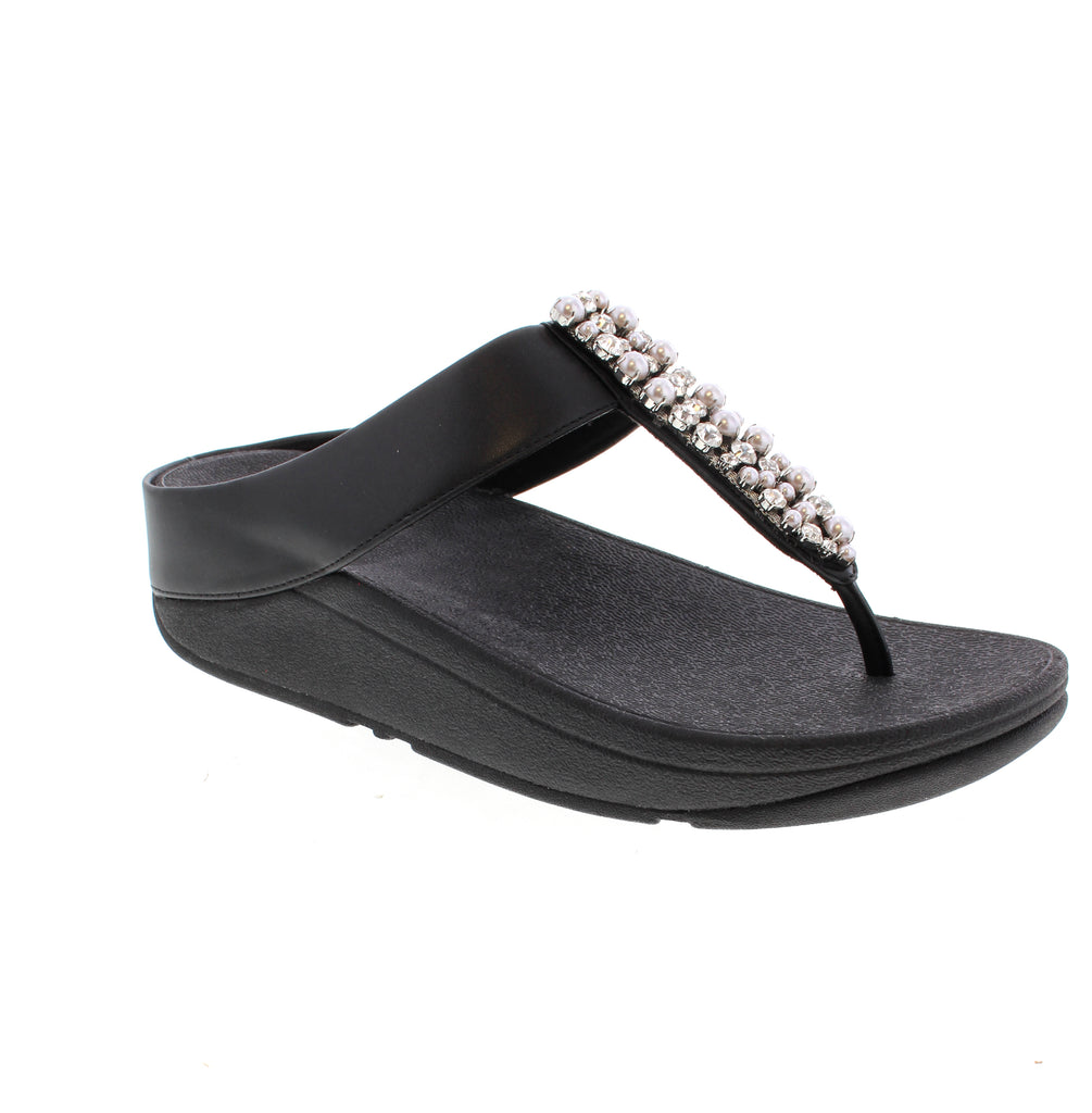 The FitFlop Fino in Black A2N-001 pairs sleek leather construction with a cushioned EVA/Foam midsole for all-day comfort. Adorned with a shimmering crystal-embellished detail, these elegant sandals transition seamlessly from day to night.