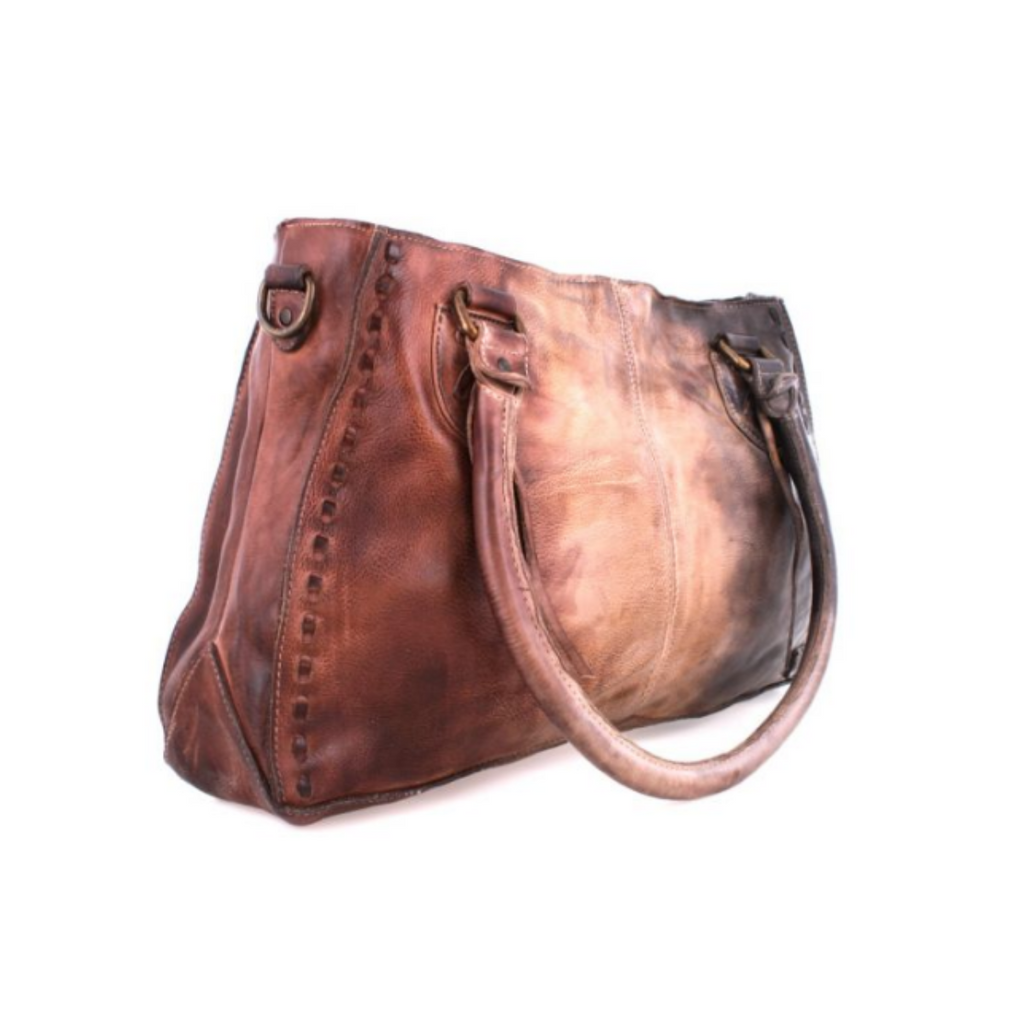 Introducing the Bed Stu Rockababy: an effortless, modern tote with a smaller silhouette and plenty of style. Crafted from premium leather, this fan favorite features padded shoulder straps, a roomy interior, a removable crossbody strap, a zip top closure, and an exterior back pocket that fits any phone. A perfect accessory to transition from day to night.