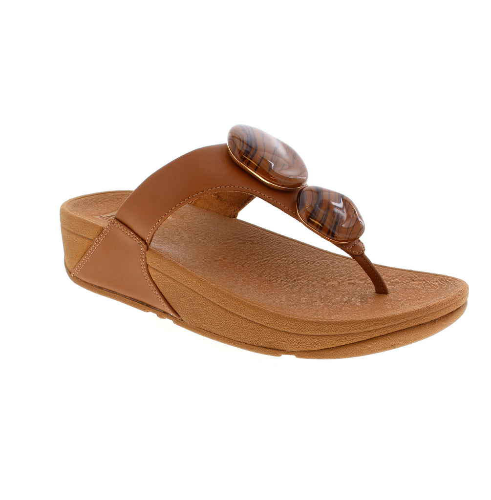 The FitFlop Lulu A4T-C15 in Tan delivers understated elegance with its refined silhouette and soft padded leather construction. Engineered with a triple-density EVA/Foam midsole that distributes pressure and absorbs impact, these sandals provide exceptional support and cushioning for all-day wear. A timeless staple designed for everyday versatility.