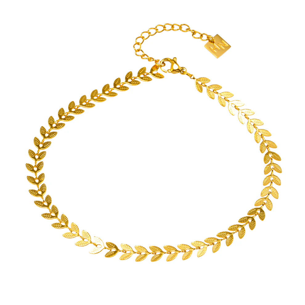The Hackney Nine Alala anklet is a stunning ode to the delicate allure of the forest. Each miniature leaf charm showcases the natural grace and elegance of nature. Take a piece of the wild with you wherever you go. This anklet is the perfect accessory to wear as its water-resistant and tarnish-free design.
