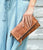 The Bed Stu Amina is the perfect multifunctional accessory for any look. Crafted from vegetable-tanned leather, this wallet, crossbody bag and clutch in one features two detachable straps, credit card slots, a cash pocket, zippered dividers and a magnetic close flap pocket with a secure snap closure. The easy slip pocket on the back is also perfect for carrying larger phones. All of these practical details make this compact bag a must-have for everyday convenience.