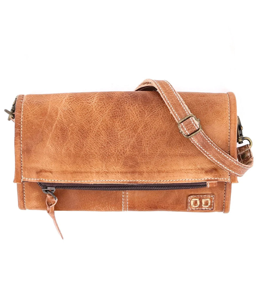 The Bed Stu Amina is the perfect multifunctional accessory for any look. Crafted from vegetable-tanned leather, this wallet, crossbody bag and clutch in one features two detachable straps, credit card slots, a cash pocket, zippered dividers and a magnetic close flap pocket with a secure snap closure. The easy slip pocket on the back is also perfect for carrying larger phones. All of these practical details make this compact bag a must-have for everyday convenience.