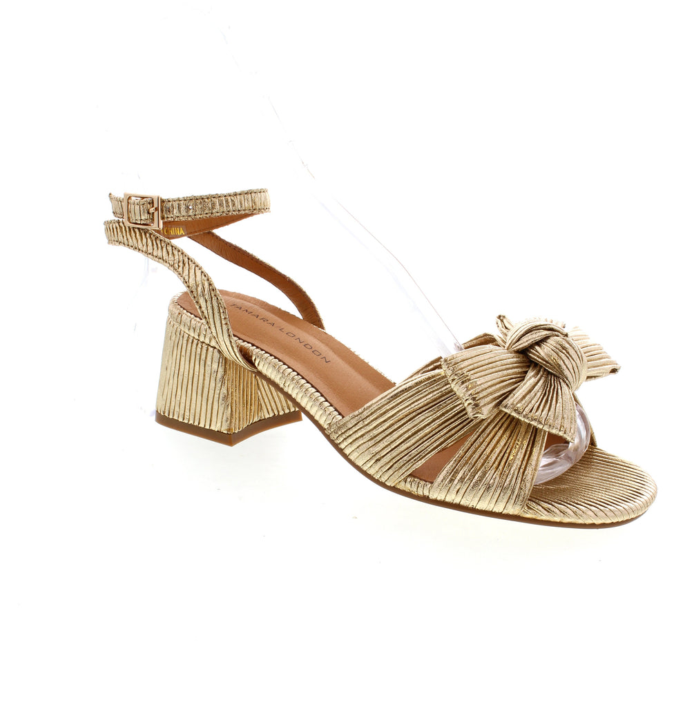 The Tamara London Auger is a stylish heel that will turn heads with its bow detailing. It offers an adjustable backstrap for security and a block heel for a touch of class. Perfect for any occasion, these heels will elevate your look and make a statement.