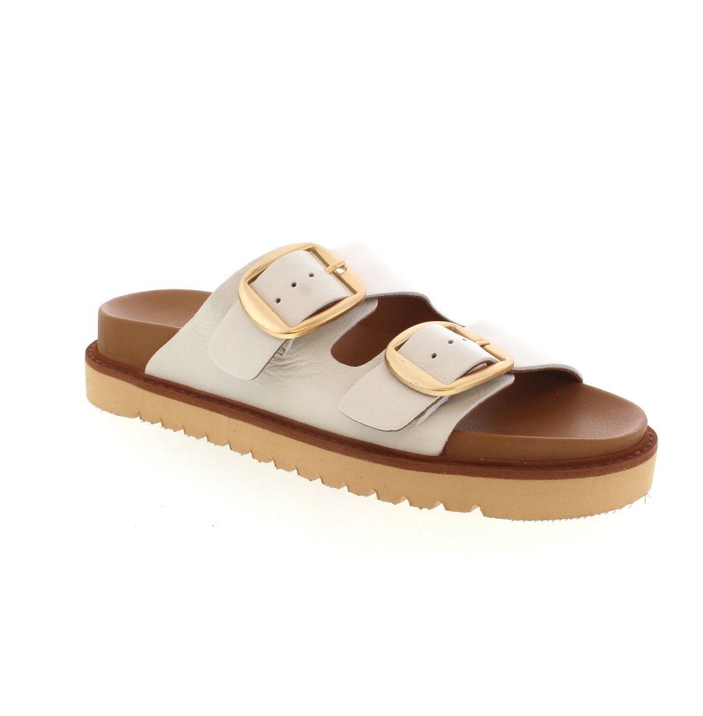 Get ready to stand out in style with Luna Sole Avery. These slide sandals feature bold metallic hardware for a fashion-forward look. Paired with linen pants or denim cutoffs, they'll elevate any outfit. With their functional design and endless versatility, they're a must-have for the season.