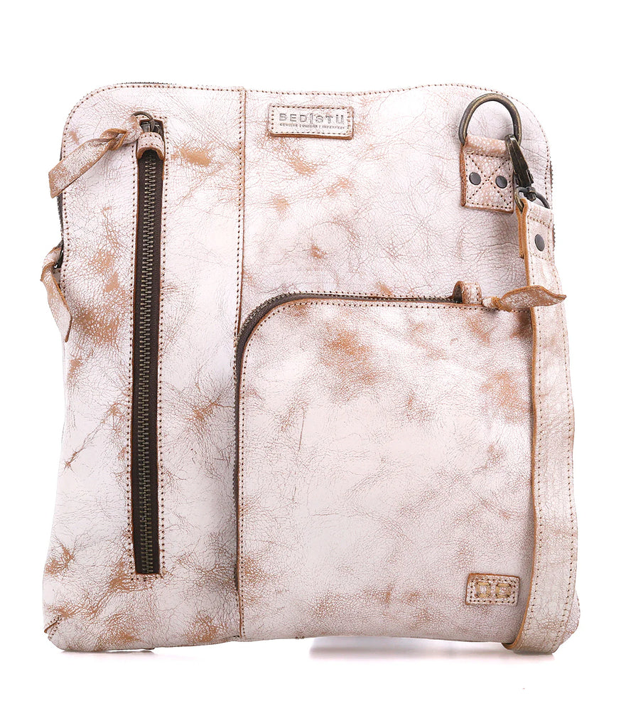The Bed Stu Aiken is a versatile bag crafted from dip-dyed vegetable-tanned leather for universal appeal. It's designed with a secure metal zip-top closure and 3 exterior zip pockets with security tabs for improved organization. Plus, you can adjust the crossbody strap for two different wear options and remove it for fuss-free carry. Take comfort in the organic cotton lining, 2 slip pockets, and ample zippered pocket. Finally, the cool X leather inlays complete the unique look.