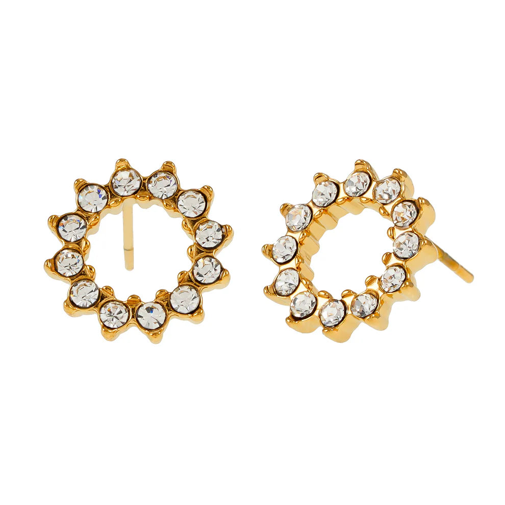 Hackney Nine Battiste - Gold features sparkling star-shaped stud earrings crafted with AAA-grade zirconia gemstones. Each earring showcases a larger central stone surrounded by a glittering halo of smaller stones that catch the light beautifully. Made from premium 18-karat gold-infused alloy, these elegant studs work for special occasions or everyday wear. Sustainable materials and conflict-free gemstones ensure responsible luxury.