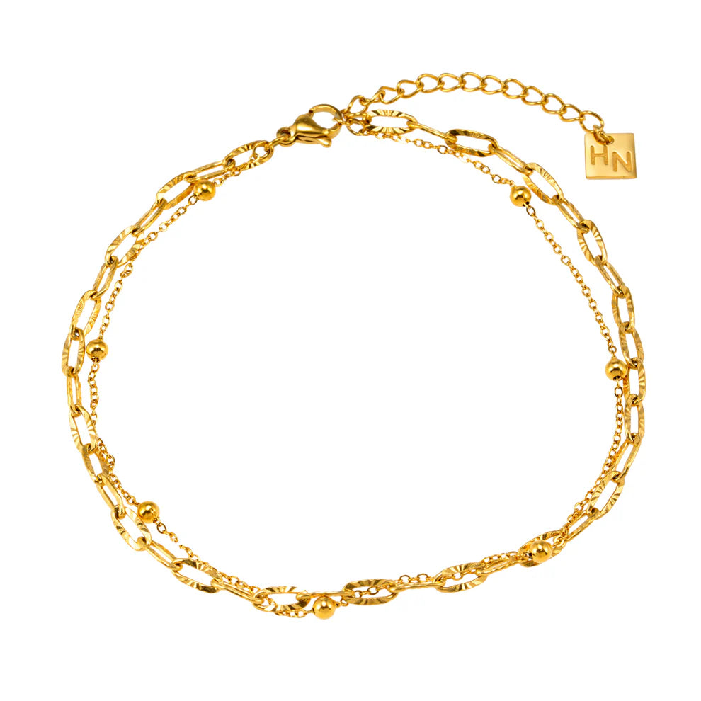 Elevate your style with the Hackney Nine Castilia Anklet. Featuring two unique chains. The textured paper clip chain and beaded chain layer together to effortlessly enhance any outfit.