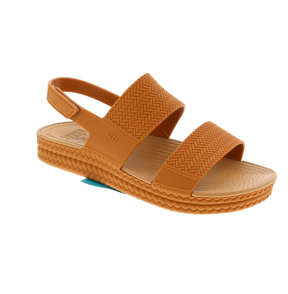 Reef Water Vista CJ8784 women's sandal in tan. Waterproof EVA/PU upper with slingback design and velcro closure for secure fit. Flatform heel with light arch support provides stability and comfort. EVA/PU midsole absorbs impact. True to size, perfect for casual summer outings and water activities.