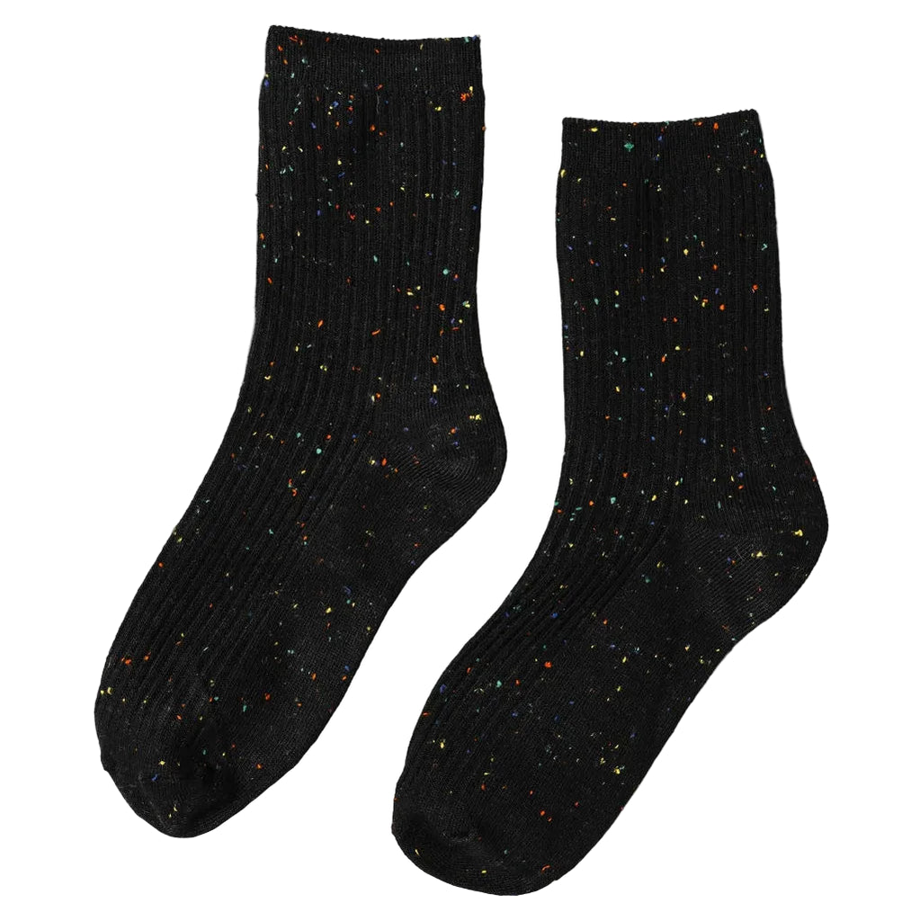 Step up your sock game with Unified Confetti Socks in Coal. These playful yet refined socks feature a signature confetti effect created by vibrant multi-coloured yarns woven throughout a premium cotton-blend base. Made from 75% cotton and 25% spandex, the fabric delivers breathability and stretch for all-day comfort. The fine rib construction hugs your foot with gentle support, keeping you comfortable from morning to night. 