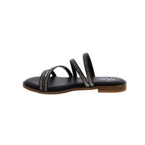 The Taxi Cora sandal is the perfect combination of fashion and comfort. The sleek black straps are adorned with sparkling rhinestones and the soft sock padding provides cushioned support. You'll love the flexibility of the outsole, allowing for all-day wear. Step into style with Taxi.