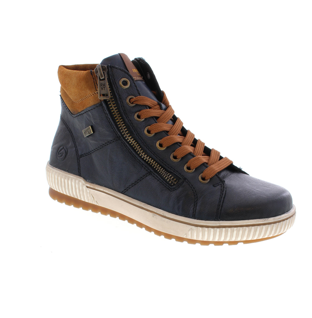 Remonte D0772-16 brings European comfort and style to everyday wear. This navy multi ankle boot features a leather upper with water-resistant protection, faux fur lining for warmth, and a supportive foam midsole paired with a rubber outsole for reliable traction. Designed with a lace-up entry and side zip for easy on-and-off.