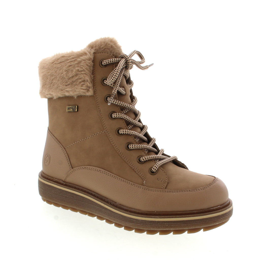 The Remonte D0U78 boots in Beige are crafted from soft suede leather. Their innovative design features both laces and a zipper, allowing for easy on and off while ensuring a secure fit. The faux fur collar adds a distinctive style element. Equipped with a flexible, cushioned sole, these boots provide excellent traction and support, promoting natural foot movement and all-day comfort. Ideal for those seeking both function and refined design.