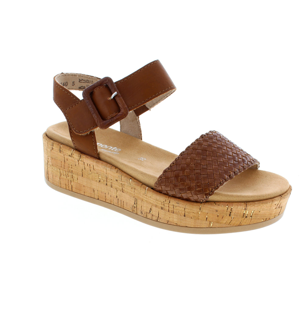The Remonte D1N56-24 is a warm brown sandal with a textured leather upper and basket weave pattern. Its elasticized upper and ankle strap closure provide a secure, adjustable fit. The wedge heel, foam midsole, and removable microfiber insole offer comfort throughout the day. Orthotic-friendly and true-to-size for narrow-to-medium feet.
