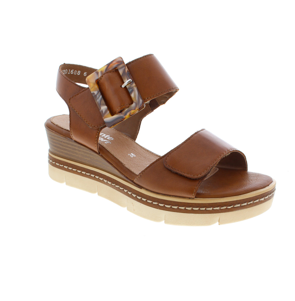 Slip into effortless elegance with the Remonte D2L53-24 sandal in rich brown. This casual summer staple features a leather upper and round toe design that pairs with everything in your wardrobe. The wedge heel adds just enough lift for all-day comfort, while dual closures velcro and halter strap give you flexibility in how you wear them