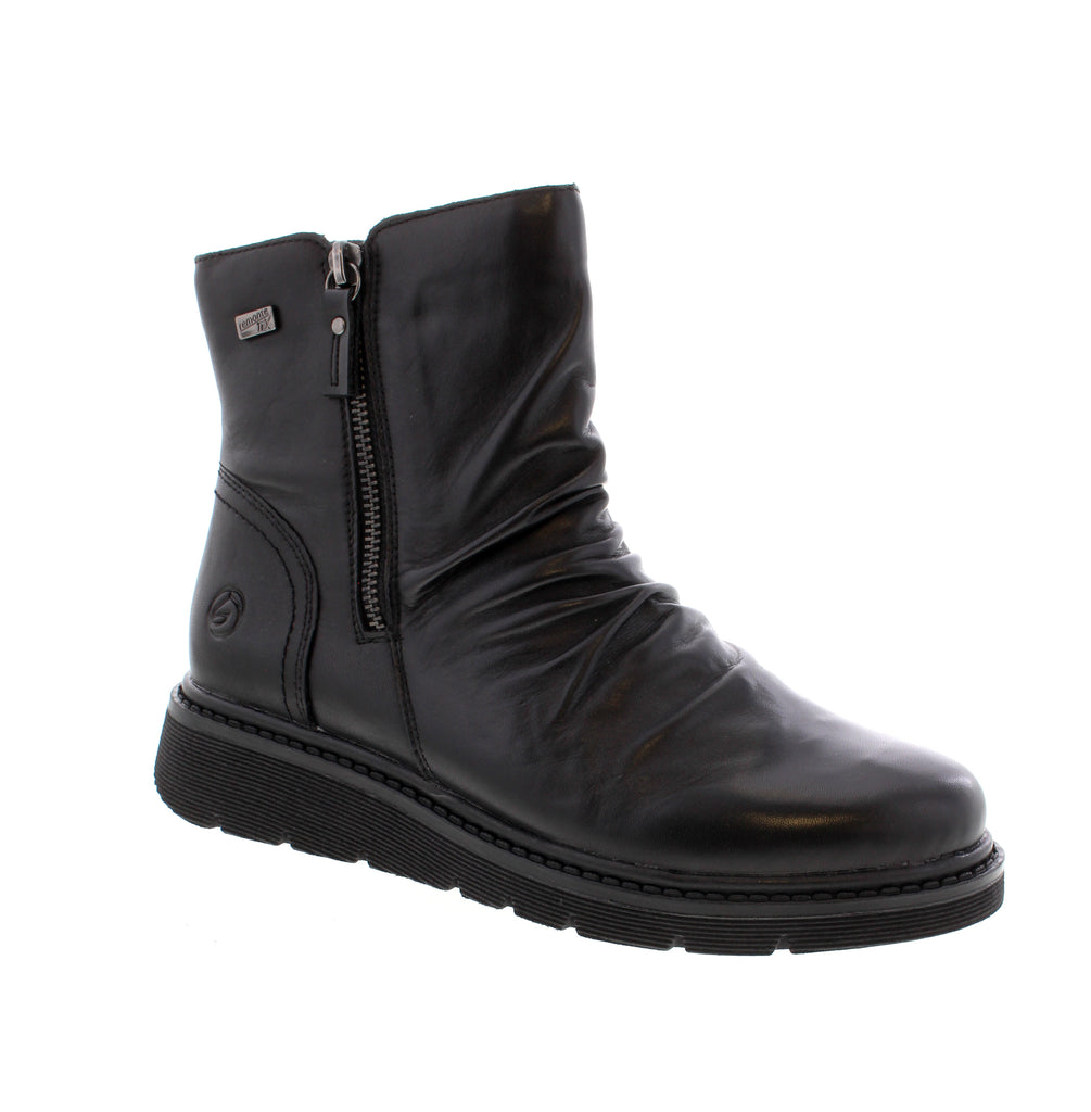 Remonte D3981-00 brings everyday comfort and style to your winter wardrobe. This black ankle boot features a leather upper with water-resistant protection, keeping your feet dry through the season. Designed for all-day wear, the D3981-00 combines a cushioned foam midsole with a removable microfiber insole for personalized comfort. The side zip entry makes it easy to slip on, while the wedge heel and round toe deliver a flattering, casual silhouette. Felt lining and insulation work together to keep warmth in