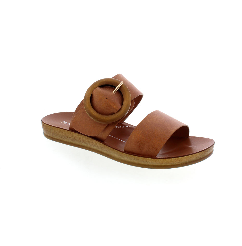 Elevate your summer style with Los Cabos Damani. These slides feature a trendy wooden buckle and adjustable strap, providing both fashion and comfort. Perfect for a casual look, these slides will be your go-to sandals all season long!