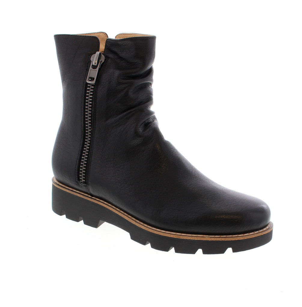 Django &amp; Juliet's Dixeya-DJ is a sleek black ankle boot that blends edgy style with everyday comfort. Featuring a leather upper, faux fur lining, and side zip entry for easy on-and-off wear. Leather upper with faux fur lining keeps your feet cozy. Man-made leather footbed and foam midsole provide cushioning and support. Rubber outsole delivers reliable traction. Side zip closure makes getting dressed effortless.