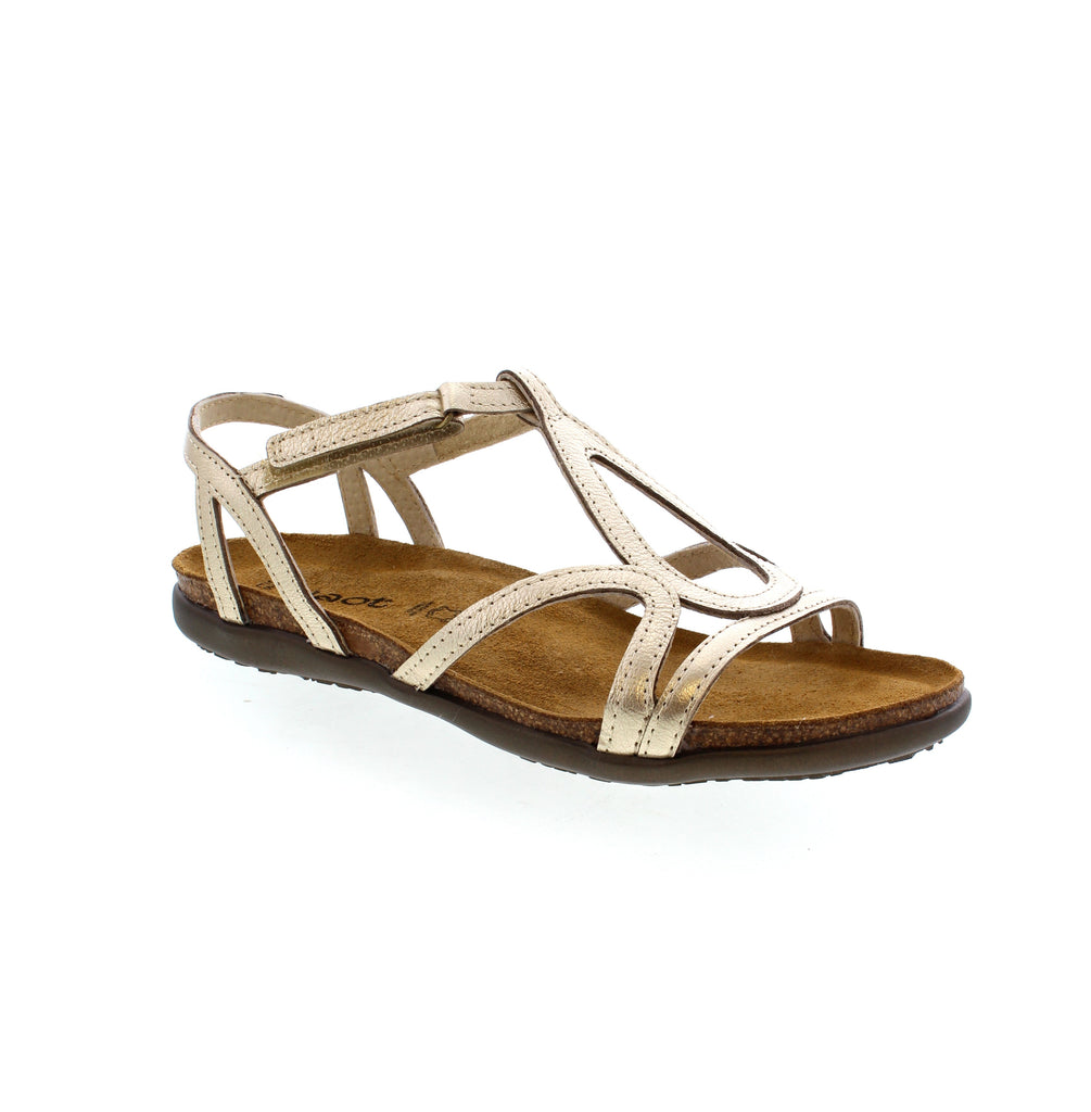 The Naot Dorith sandal offers gladiator-inspired style with added stability and support from a hook &amp; loop strap and backstrap. The anatomic cork &amp; latex footbed, wrapped in soft suede, molds to the foot for ultimate comfort. With a feminine design and .75" TPR sole, this sandal combines fashion and function.