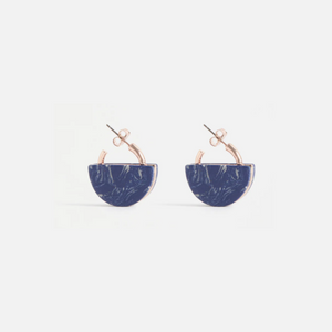 The Elk Kriis earring is a showstopper—a semi-circular deep blue stone set intricately in a gold frame. Perfect for day or night, this versatile style is sure to make heads turn with effortless style.