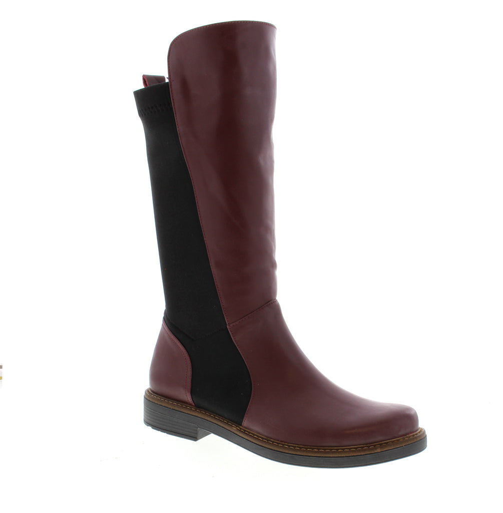 Sleek and versatile, the Bueno Ebru in burgundy is a wardrobe essential that transitions effortlessly from day to night. This mid-calf boot combines timeless style with everyday comfort. Leather upper with elasticized construction for easy on-and-off wear. Soft leather lining and cushioned leather footbed provide all-day comfort. Foam midsole absorbs impact, while the durable rubber outsole delivers reliable traction. Round toe and block heel create a flattering silhouette.
