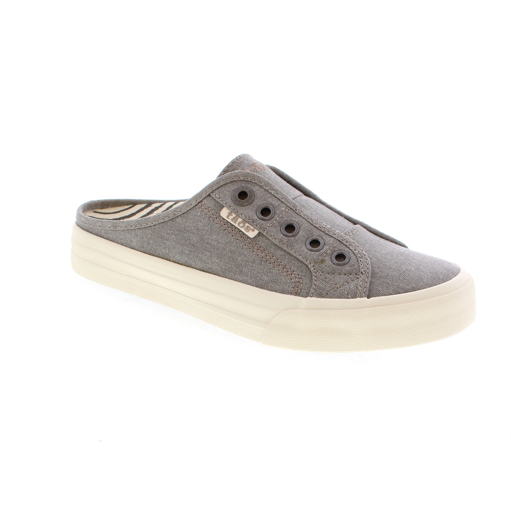 Slip into comfort with these Taos Ez Soul washed canvas mule sneakers. Designed with a lace-less silhouette, adjustable fit panels, and removable antimicrobial footbeds, they deliver all-day support and freshness. Durable soles and flexible construction make them the perfect grab-and-go shoe for everyday wear.