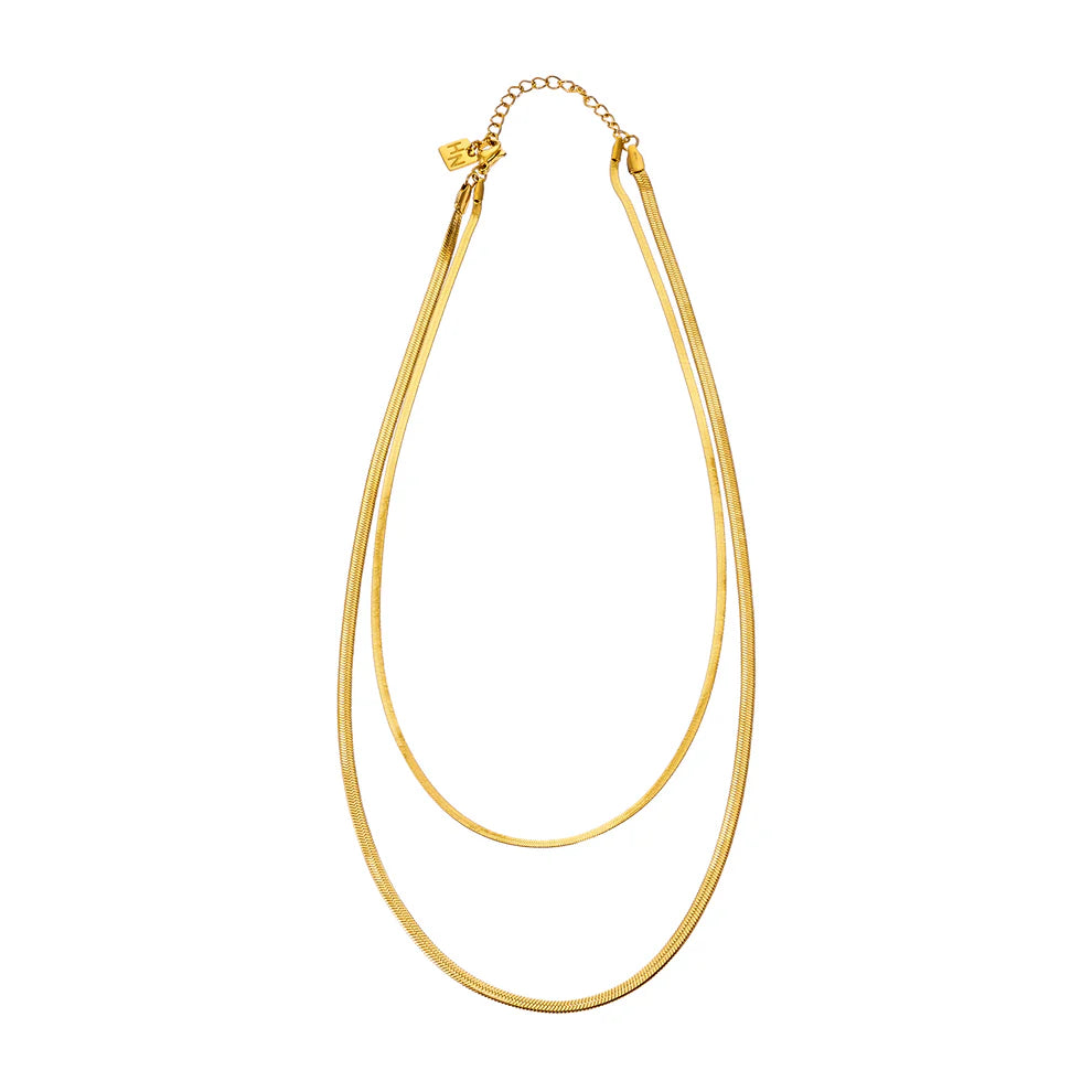 Elevate your everyday look with the Hackney Nine Ginta necklace in radiant gold. This two-layer design features a striking snake-skin texture that catches the light beautifully. Crafted from premium gold-infused alloy with sustainable natural stones and freshwater pearls, it's a piece that combines timeless elegance with modern flair.
