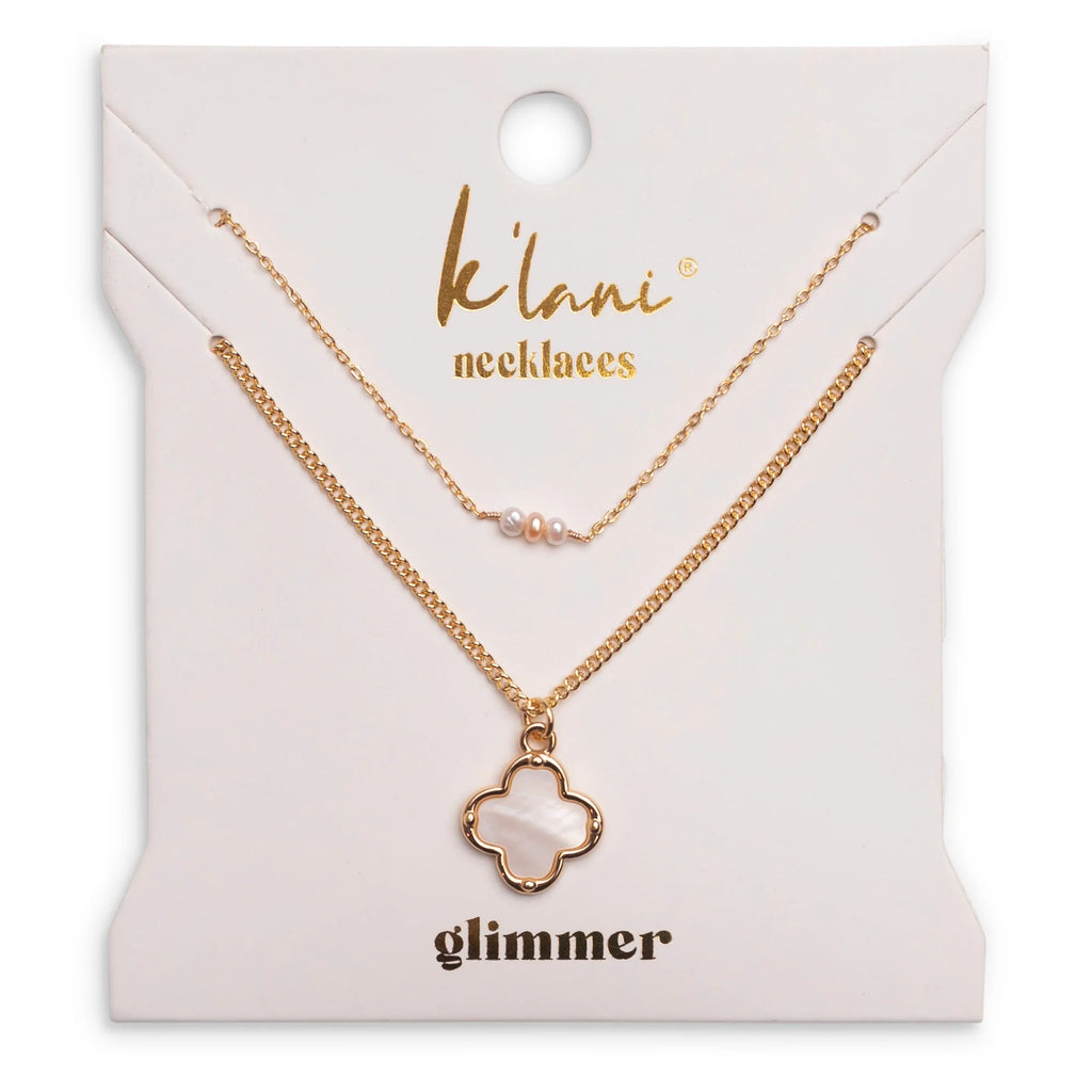 Add elegance to your everyday look with the K'lani Glimmer Necklaces. Featuring luminous pearl accents and warm gold tones, this versatile set works beautifully on its own or layered. Wear as a reminder that even the small moments can hold a glimmer of shine