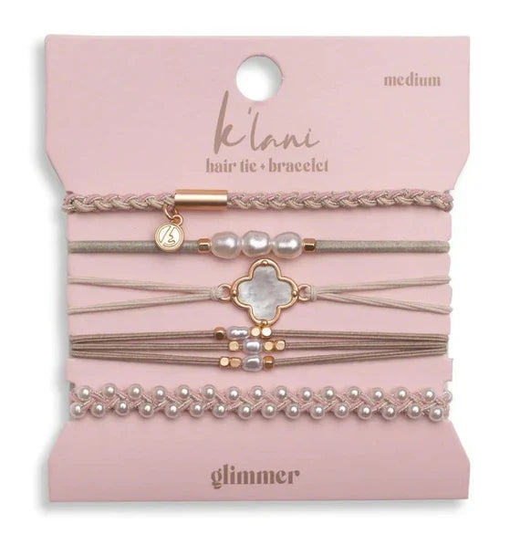 The K'lani Glimmer hair tie/bracelet set comes with 5 pieces in light tones. Accented with pearl and rose gold tones, these convertible accessories will add some glow to your wrist or hair.