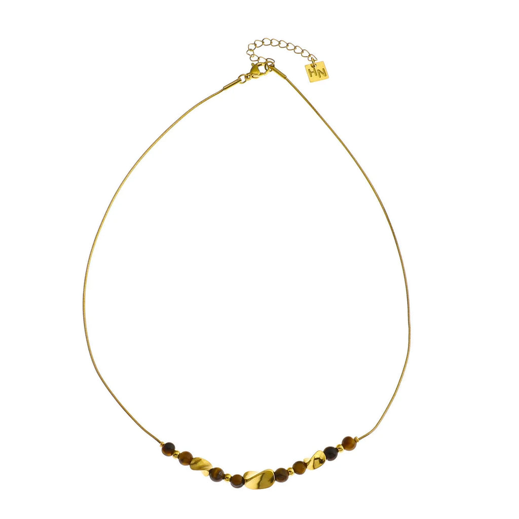 Hackney Nine Havana has a refined collection of Tiger’s Eye stones and lustrous gold-toned charms that adds subtle color and natural elegance to this contemporary snake-skin textured chain necklace. The organic beauty of the stones contrasts beautifully with the sleek modern chain, creating a sophisticated statement with effortless appeal.