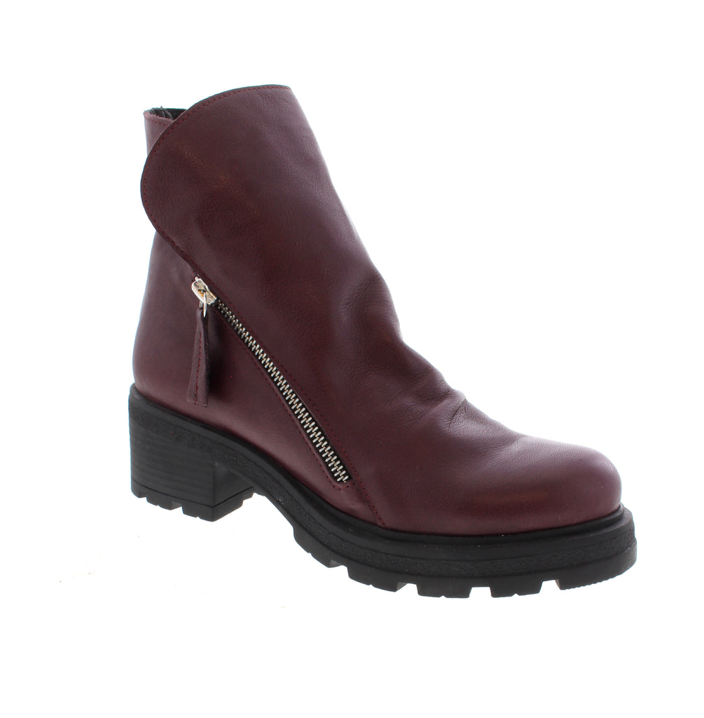 The Bueno Holden in Purple is a versatile ankle boot that blends everyday comfort with bold style. Crafted with a leather upper, lining, and footbed, this boot delivers durability and support for casual wear. Featuring a foam midsole and rubber outsole for cushioning and traction, the Holden includes a convenient side zip entry for easy on-and-off. The block heel and round toe create a flattering silhouette, while the combat boot design adds an edge to any outfit.