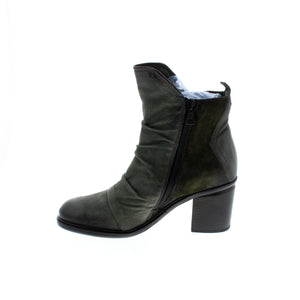 The Miz Mooz Jackey ankle boots are the perfect blend of style and comfort. The buttery soft leather and suede upper is complemented by ruching detailing and a unique cut. Cushioned insoles and rubber soles provide all-day comfort with an effortless fit. A must-have for any fashion-forward wardrobe.